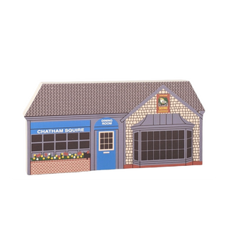 wooden replica of a building with 'Chatham Squire' branding with flowers and blue door
