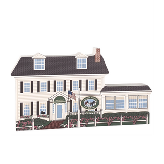 wooden replica of a two-story inn with a sign that says chatham wayside inn
