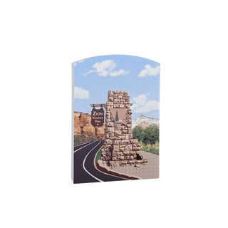 3/4" wooden replica with an illustration of a stone monument with a scenic background on a white background