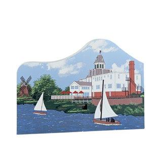 Wooden building of a building with sailboats on a lake and a windmill.