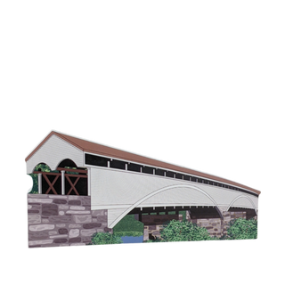 3/4" thick wooden cutout of  a covered bridge with stone walls and wooden roof on a white background