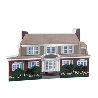 3/4" thick wooden replica with an illustration of a  two-story house with a brown roof and green exterior.