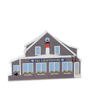 wooden replica with design of a lighthouse building with 'The Lighthouse' sign on the front 