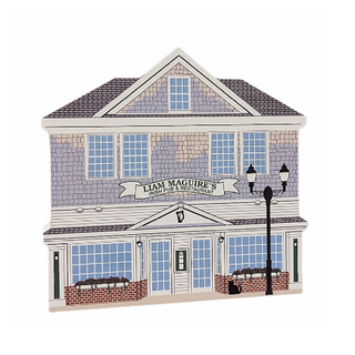 wooden replica with a design of Liam Maguire's Irish Pub & Restaurant with gray roof and white walls.
