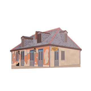 3/4" thick wooden illustration of a small building with a sign on a white background