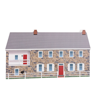 wooden replica with an illustration of a stone house with a gray roof on a white background