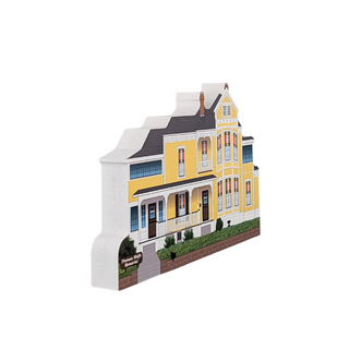 3/4" thick wooden cutout of a Yellow house model with a white roof on a white background