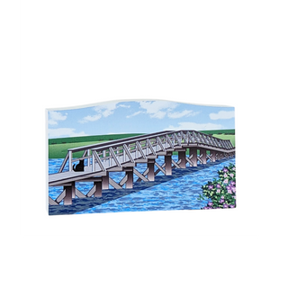 Wooden replica with a  bridge over water with green fields and blue sky
