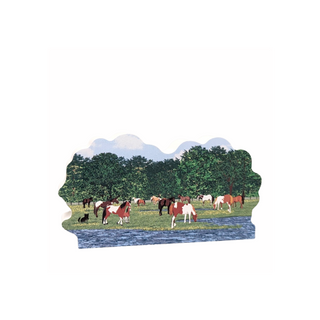 3/4" thick wooden cutout of horses grazing in a field with trees and mountains in the background.