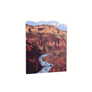3/4" thick wooden illustration of a canyon with a river and boats on a white background