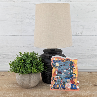 Decorative 3/4" thick wooden Indiana map with a lamp and plant on a wooden surface.