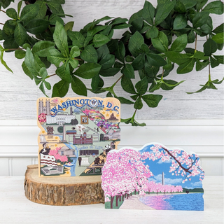 3/4" thick wooden illustrations of Washington D.C. map and cherry blossom trees with the Washington Monument and a lake on display