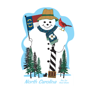 3/4" thick wooden cutout of a Snowman with North Carolina flag, cardinal, and trees on a blue background