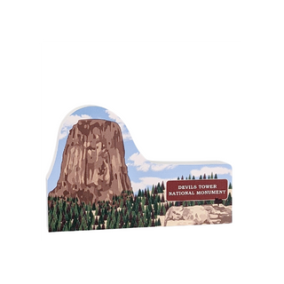 3/4" thick wooden cutout of  Devils Tower National Monument with a sign and trees.